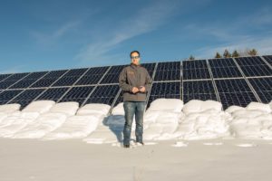 Nils Behn, CEO and President of Aegis Renewable Energy, stands in front of solar panels at Kingsbury Companies in Waitsfield. Photo by Erica Houskeeper.