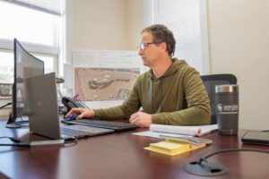 Nils Behn, CEO and President of Aegis Renewable Energy, works at his office in Waitsfield. The company employs 12 people. Photo by Erica Houskeeper.