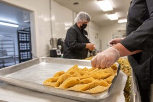 Employees at work in Global Village Foods headquarters in Quechee. The Flexible Capital Fund and Fair Food Fund provided Global Village Foods with $500,000 in financing in July 2022, split evenly between the two entities. Photo by Erica Houskeeper.